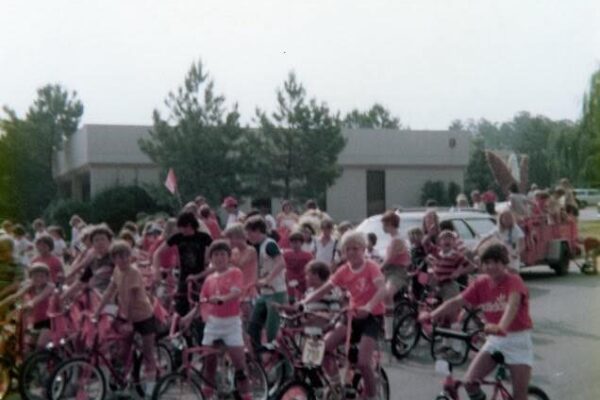 older photo from the 70s of people several kids on bikes at Dunwoody 4th of July parade