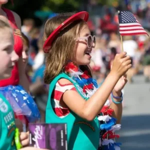 bystander children watching DHA 4th of July parade wearing their girl scout uniform