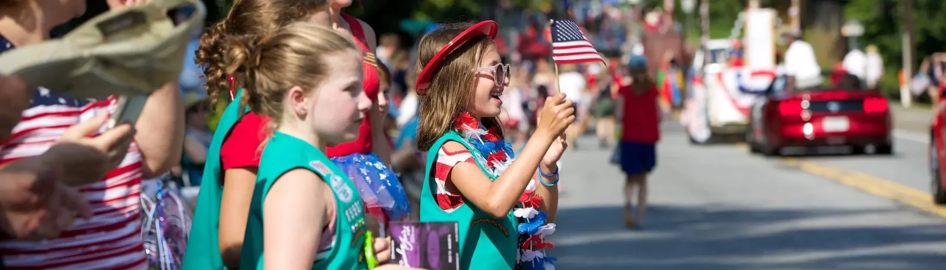 bystander children watching DHA 4th of July parade wearing their girl scout uniform